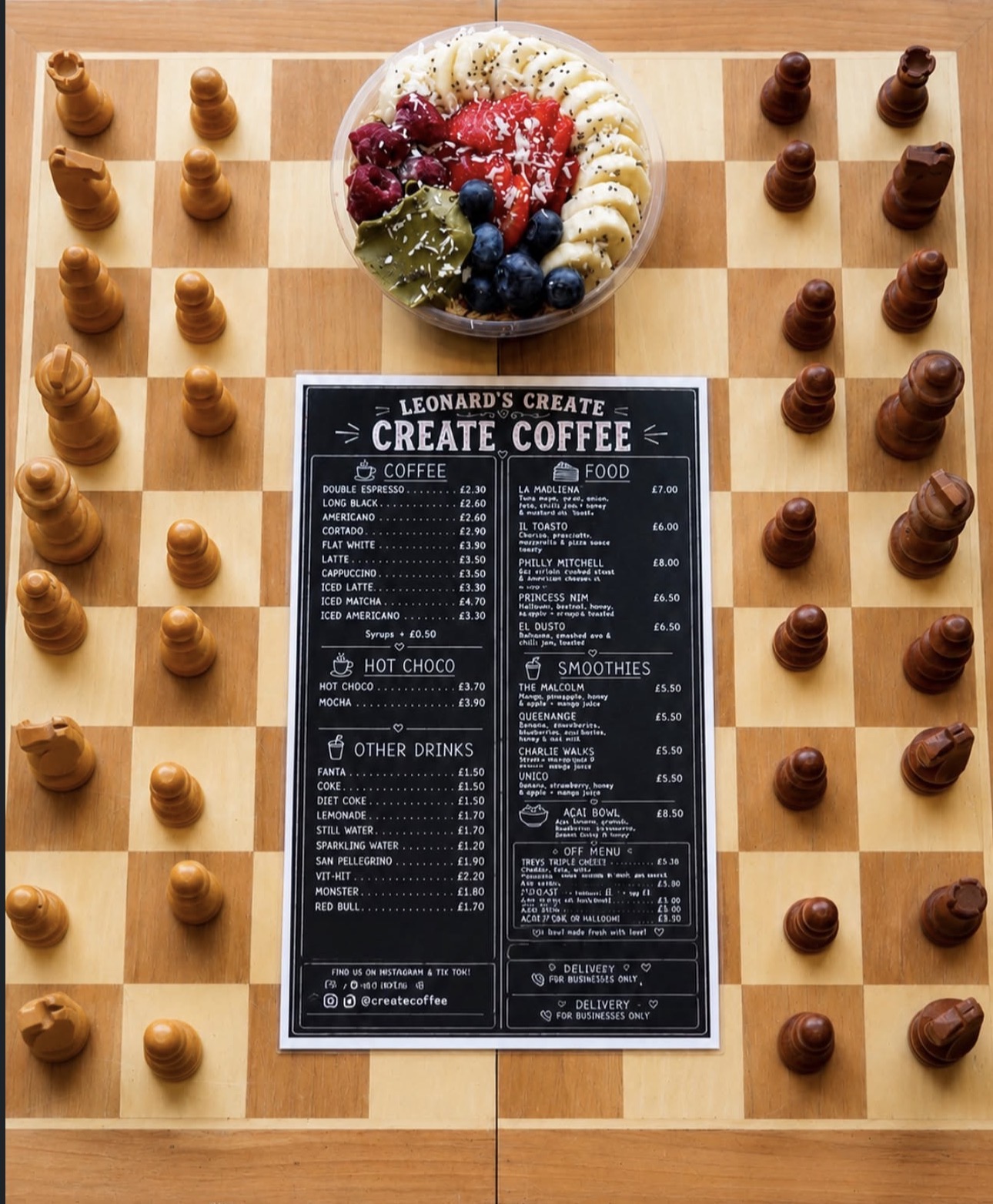 Create Coffee's menu and a fruit bowl arranged on a chessboard